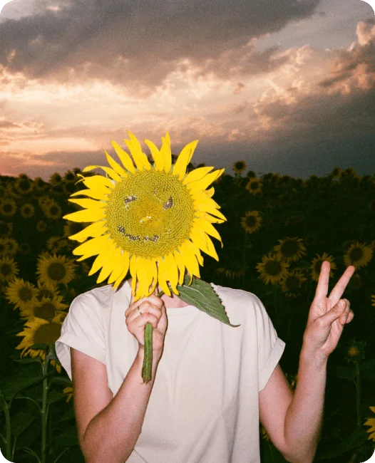 A human covering face with sunflower