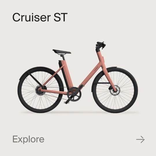 A graphic composition showing a Cowboy Cruiser bike. Text in the image reads "Cruiser" and "explore".