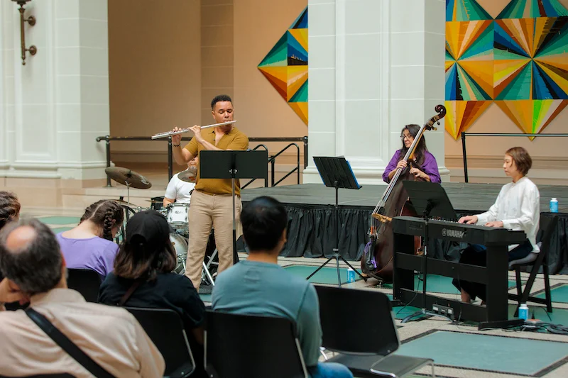 Musicians performing in front of a seated audience