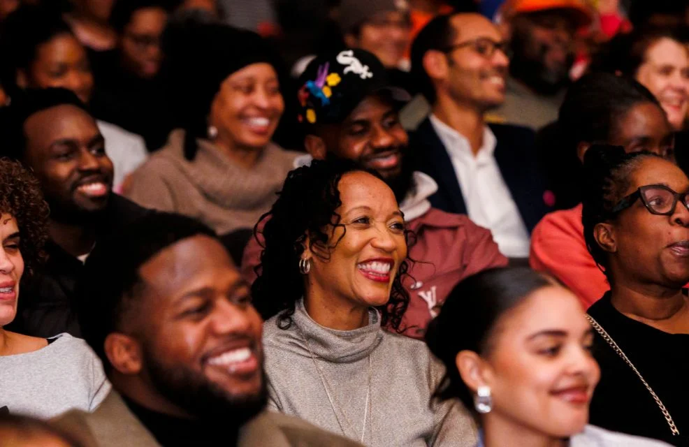 A group of seated people smiling