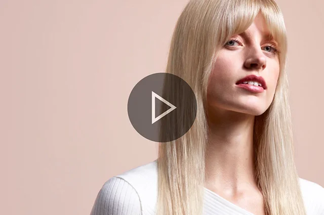 Model with long blonde hair styled into a Naturally straight blow out