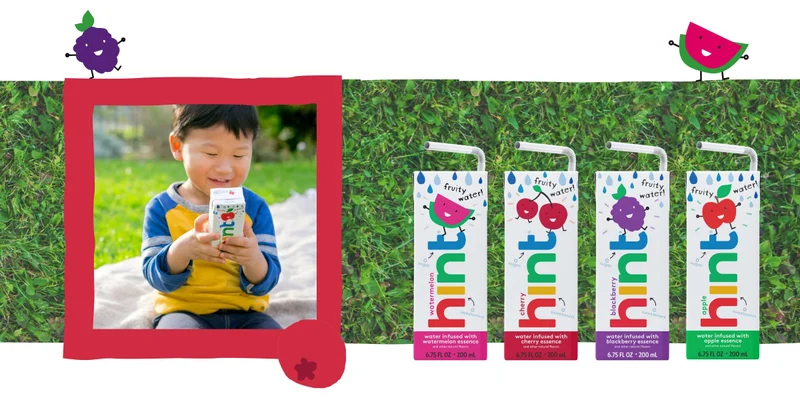 Child at a park with a pouch of Hint Kids