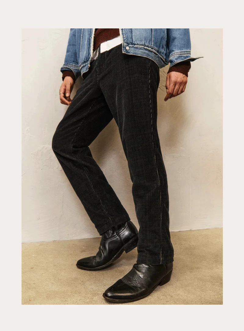 PERSON WEARING CORDUROY PANTS