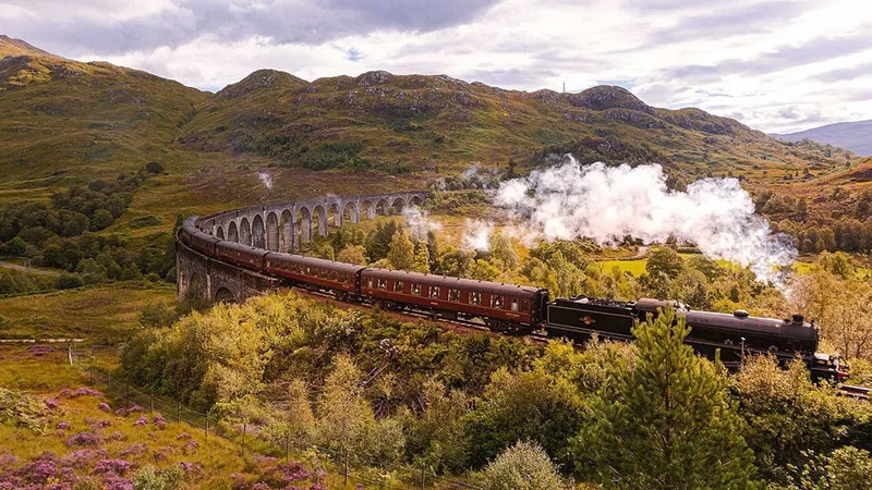 Image description: The Jacobite steam locomotive over Scotland’s Glenfinnan Viaduct railway viaduct.