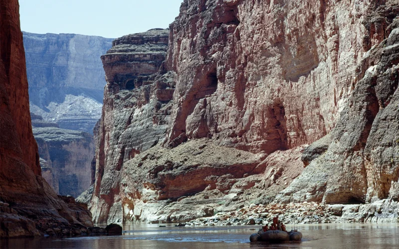In a niche of time, National Geographic's river-runners glide down a placid stretch of the Colorado in Marble Canyon, northern entrance to Grand Canyon. Man-dwarfing cliffs rear ever higher as the river plunges into the rocky abyss of the ages. Each stratum of stone marks a page in earth's biography.
