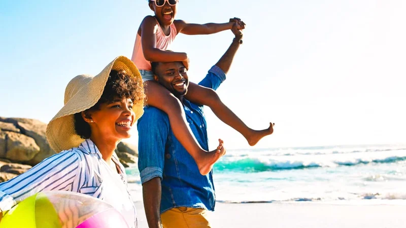 Image description: Family walking together on the beach.