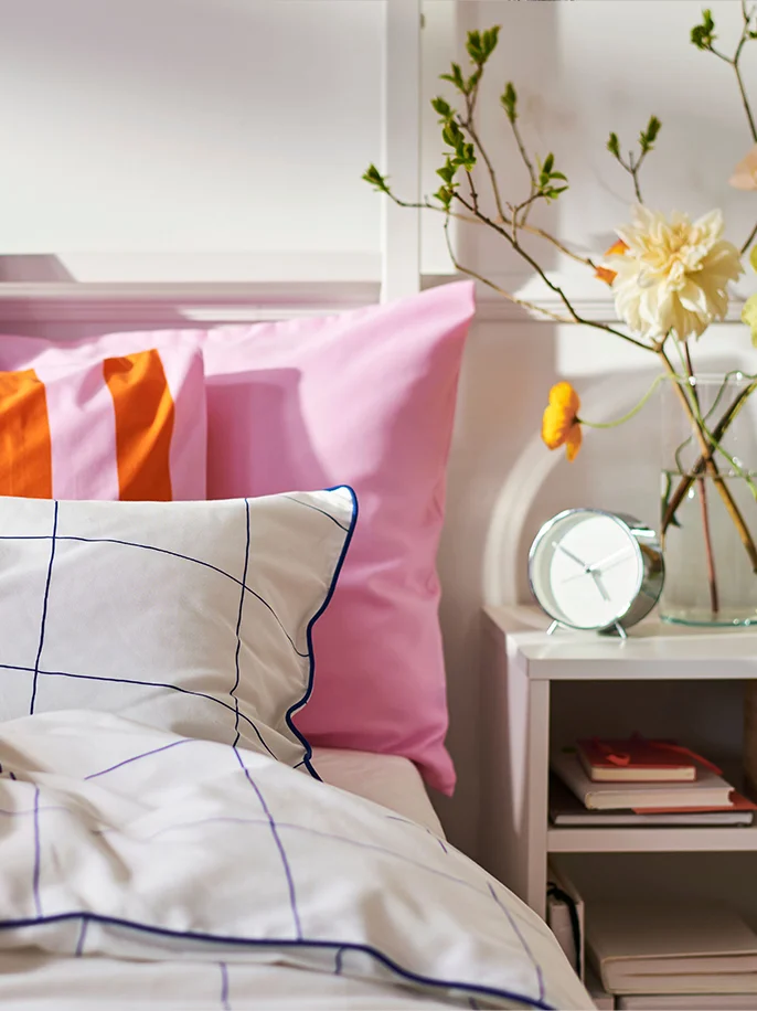 Bedroom with pink, orange, black and white bedding