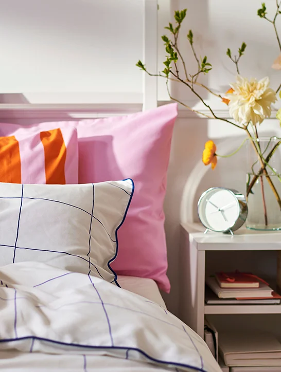 Bedroom with pink, orange, black and white bedding