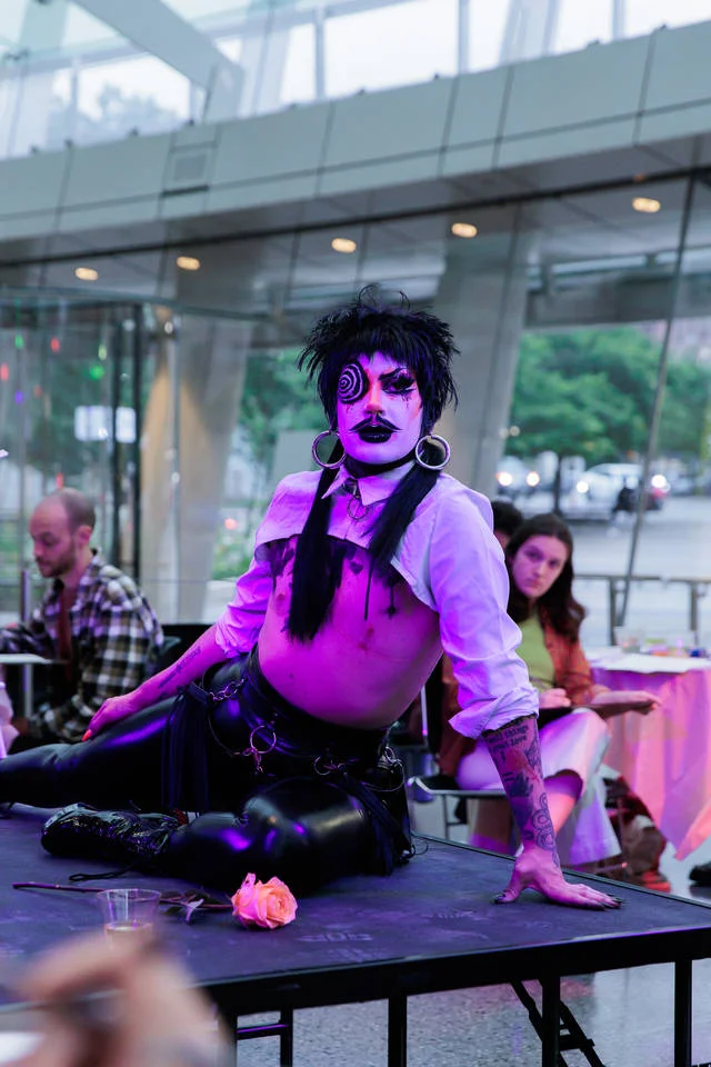 A drag performer posing on a stage