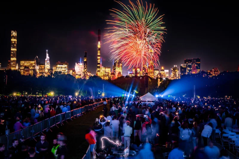 People watching fireworks in front of the Manhattan skyline