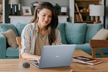 A person enjoying working from home on a Dell laptop computer.