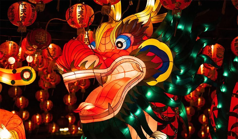 Image Description: Dragon and lanterns lit up for Lunar New Year parade