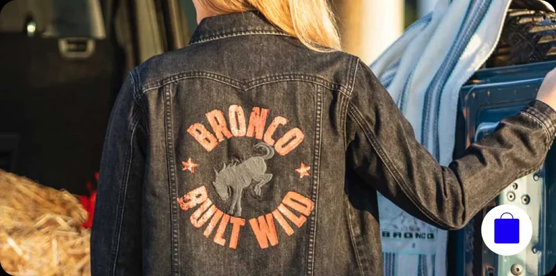 A woman wearing a Ford Bronco jacket.