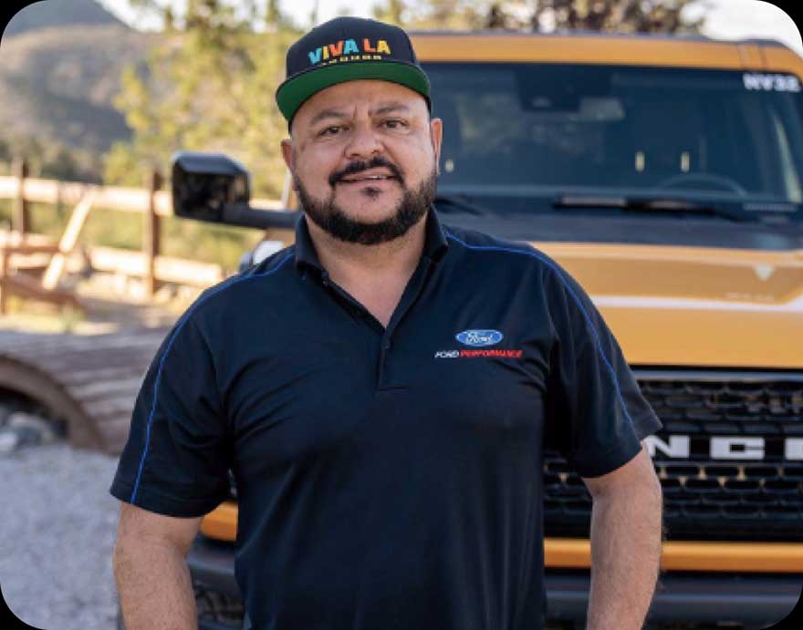 A man standing in front of a Bronco.