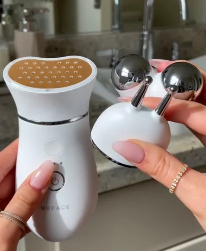 Hand holding TRINITY+ device along with The Effective Lip & Eye attachments
