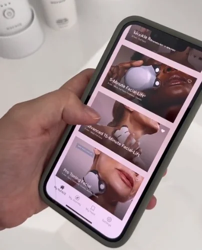 Hand holding phone with NuFACE Smart App open