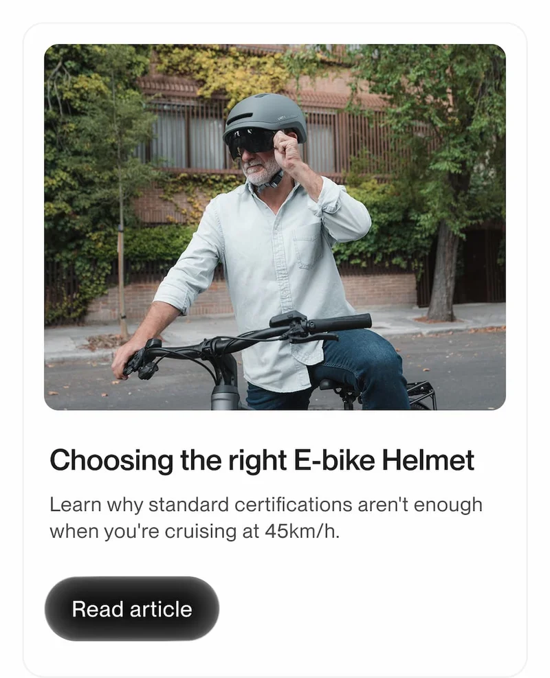 E-bike rider wearing a protective helmet while stopped on a city street