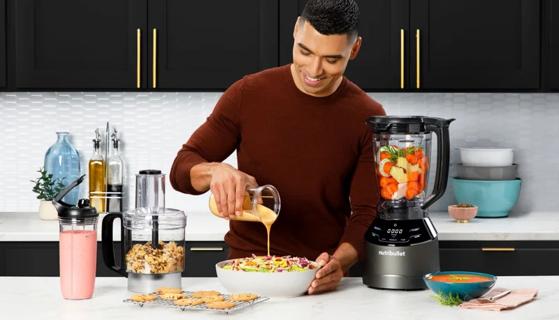 Man in a modern kitchen using the nutribullet Triple Prep to prepare a meal.