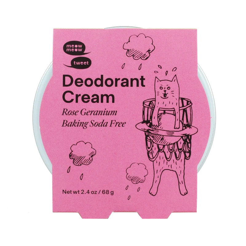 A white metal tin of deodorant cream with a pink paper sleeve.