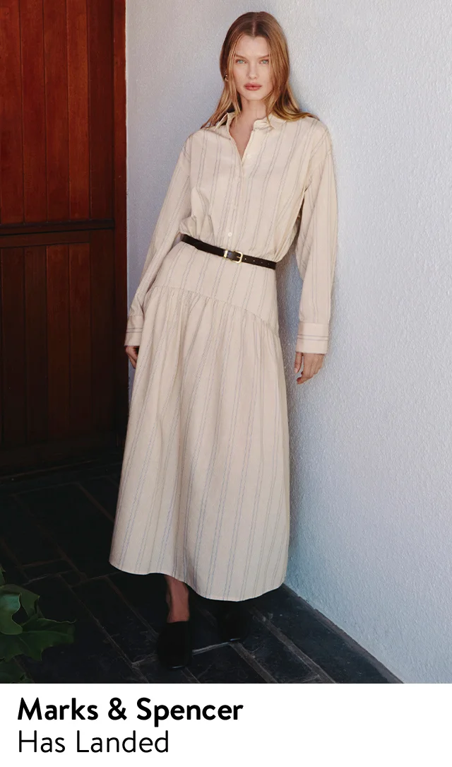 A woman wearing a striped shirtdress with a belt.