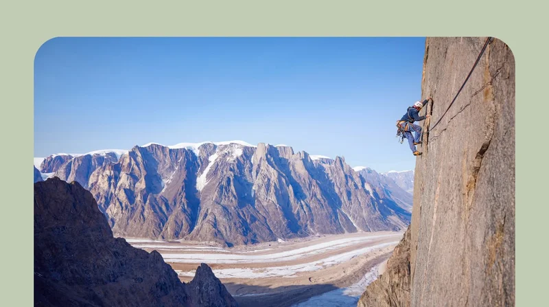 A climber high on a wall in Greenland.