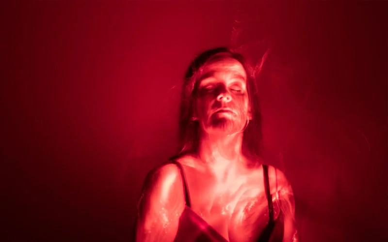 Lisa Davis, age 44, poses for a portrait under a red light in Berkhamsted, U.K.