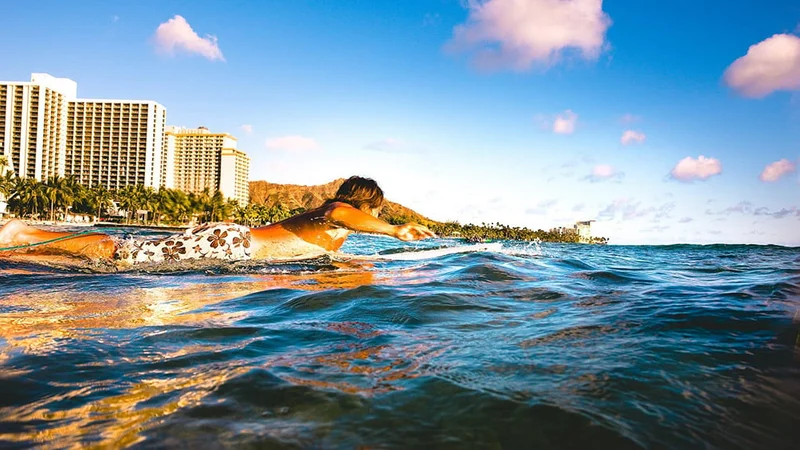 Image description: Man surfing at Waikiki Beach, Honolulu.
