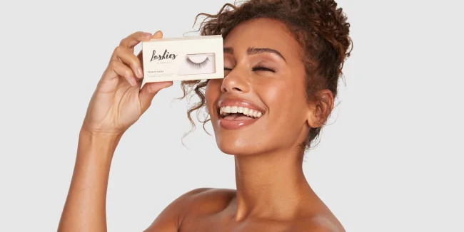 Model Smiling holding Moxielash Lashies