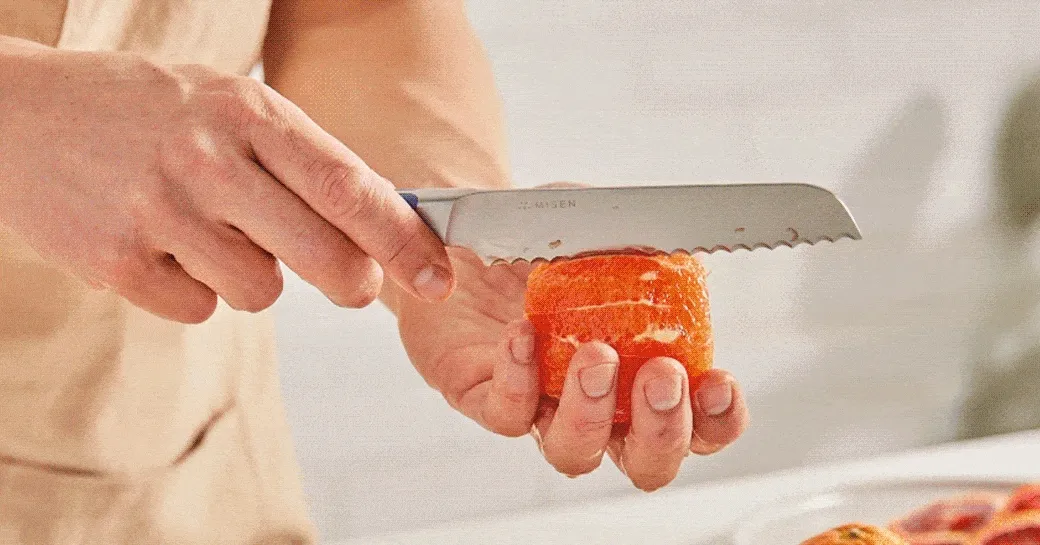 GIF of Misen serrated knife slicing an orange