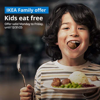 Kid holding a plate of meatballs and one in their mouth