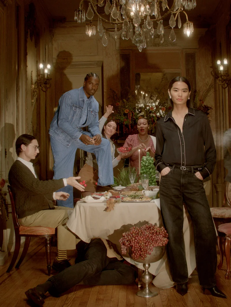 Group of people posing near a dinner table
