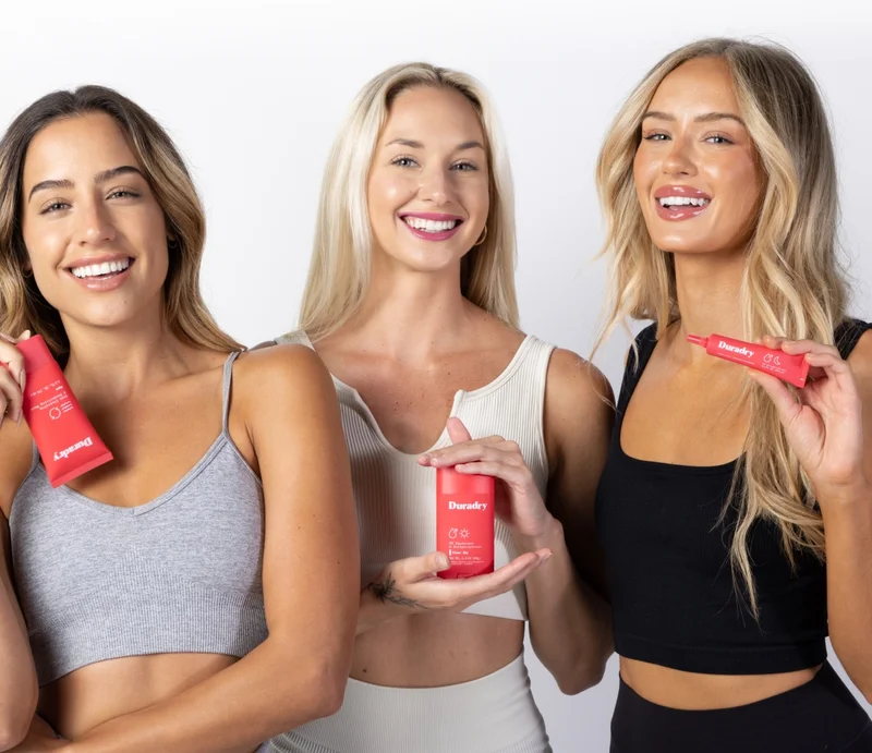 Three women holding Duradry products