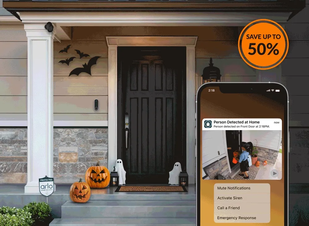 Get up to 50% off. Various Arlo security products near the front door of a home decorated with Halloween decor.