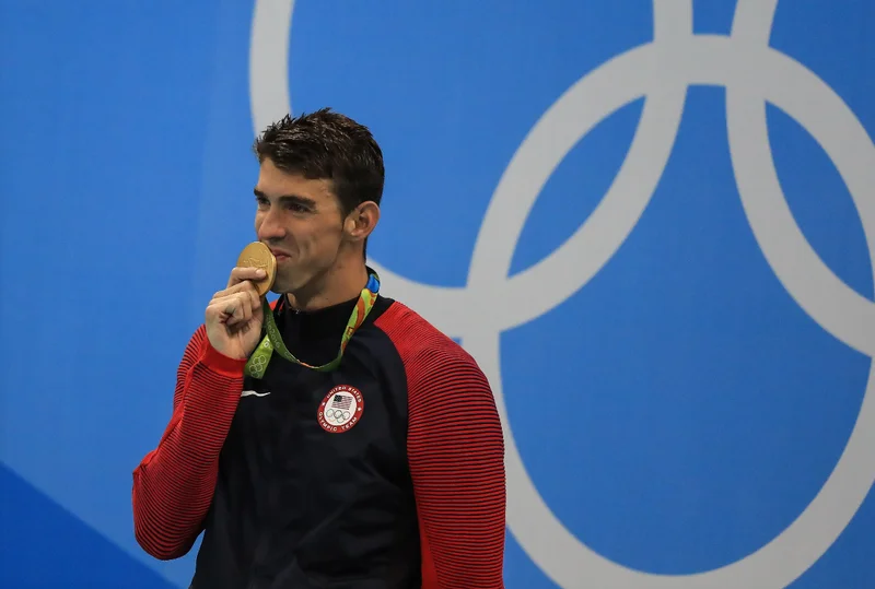 An athlete kissing a gold medal
