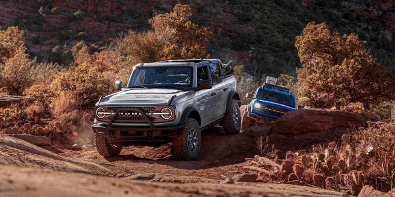 Two 2023 Ford Broncos off‑roading.
