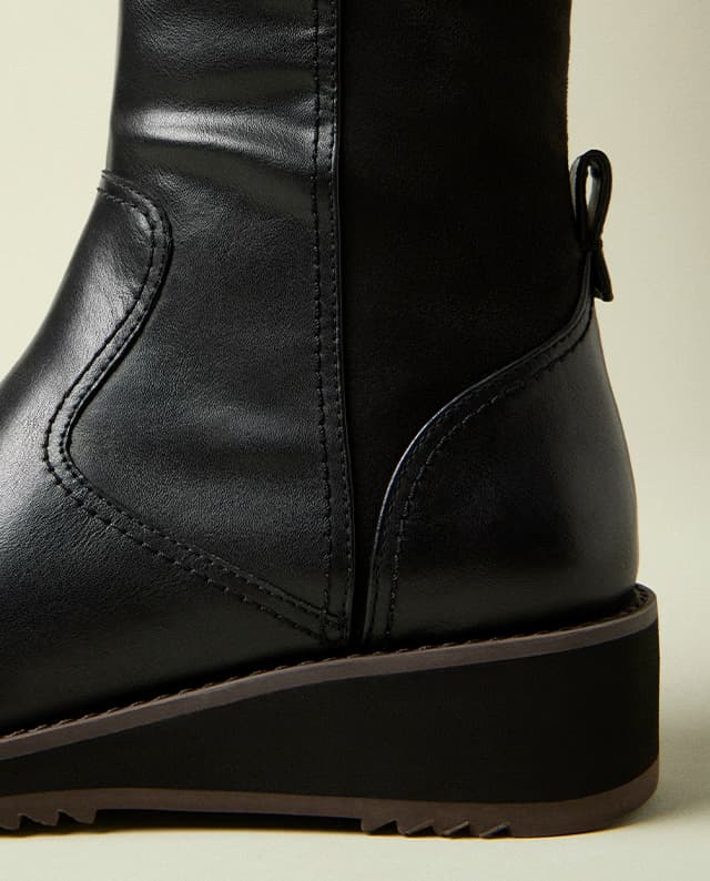 A close-up of the bottom of the Madi Boot, highlighting the style's walkable wedge. Shop Now