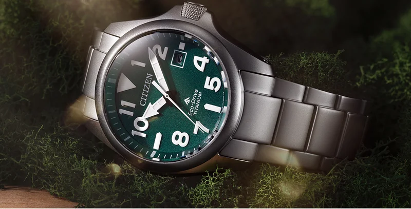 A close-up shot of the Promaster Tough watch in a silver-tone Super Titanium™, with matching bracelet. White markers against a deep green dial ensure high legibility.
