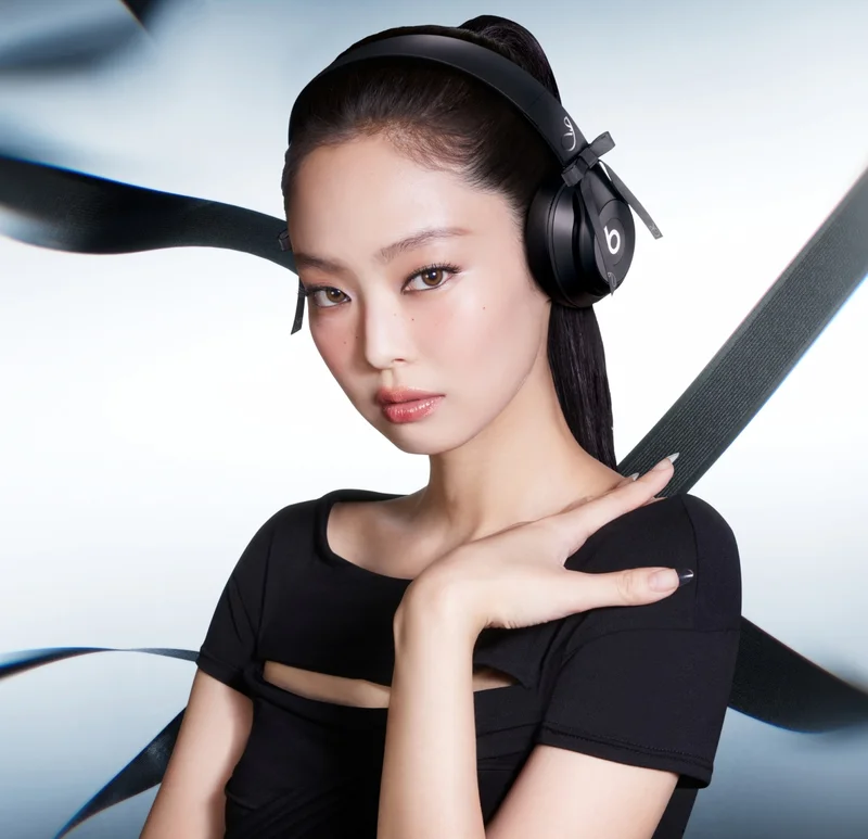 Beats logo and Jennie logo shown above Jennie Kim wearing the special-edition JENNIE Beats Solo 4 headphones in Onyx Black.