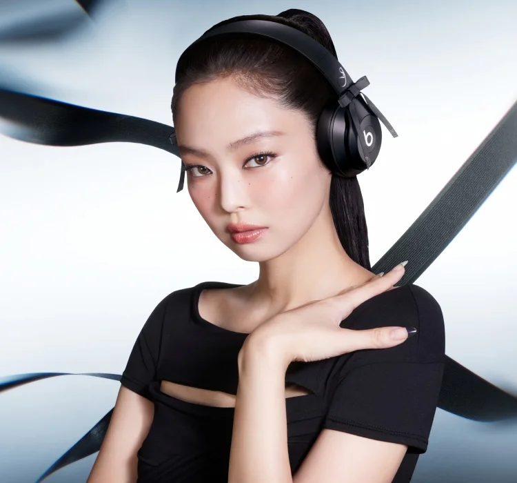 Beats logo and Jennie logo shown above Jennie Kim wearing the special-edition JENNIE Beats Solo 4 headphones in Onyx Black.