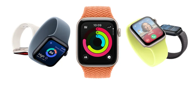 Five Apple Watch SE 3 devices. Left to right: The first in Starlight Aluminum is downward facing. The second in Midnight Aluminum is tilted at a 45 degree angle with the display showing the time and a sleep score. The third Apple Watch SE in Starlight Aluminum in the center of the picture faces front with the display showing the time and other dynamic data. The fourth in Starlight Aluminum is tilted, displaying an incoming call from a picture of a person with a smiling face named Ashley. A fifth image of an Apple Watch SE in Midnight Aluminum displays a side view of the watch face with the temperature, time, and other dynamic data visible.