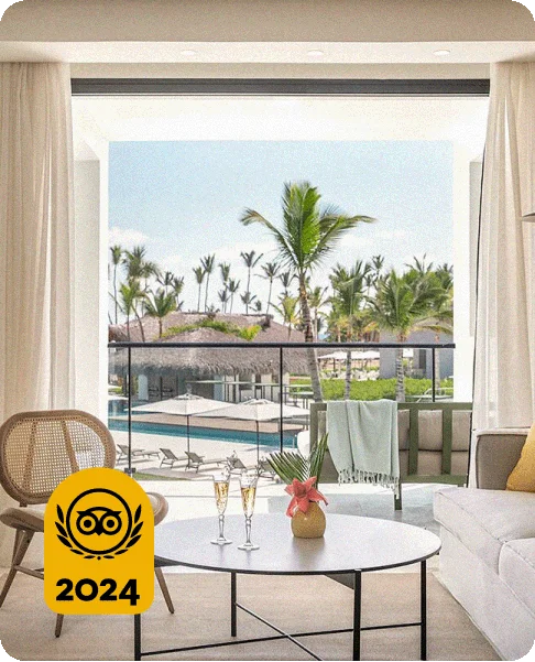 Image Description: A balcony overlooking a pool with two glasses of champagne on a table. A gold 2024 Travelers’ Choice Award Best of the Best badge is on the bottom left corner.