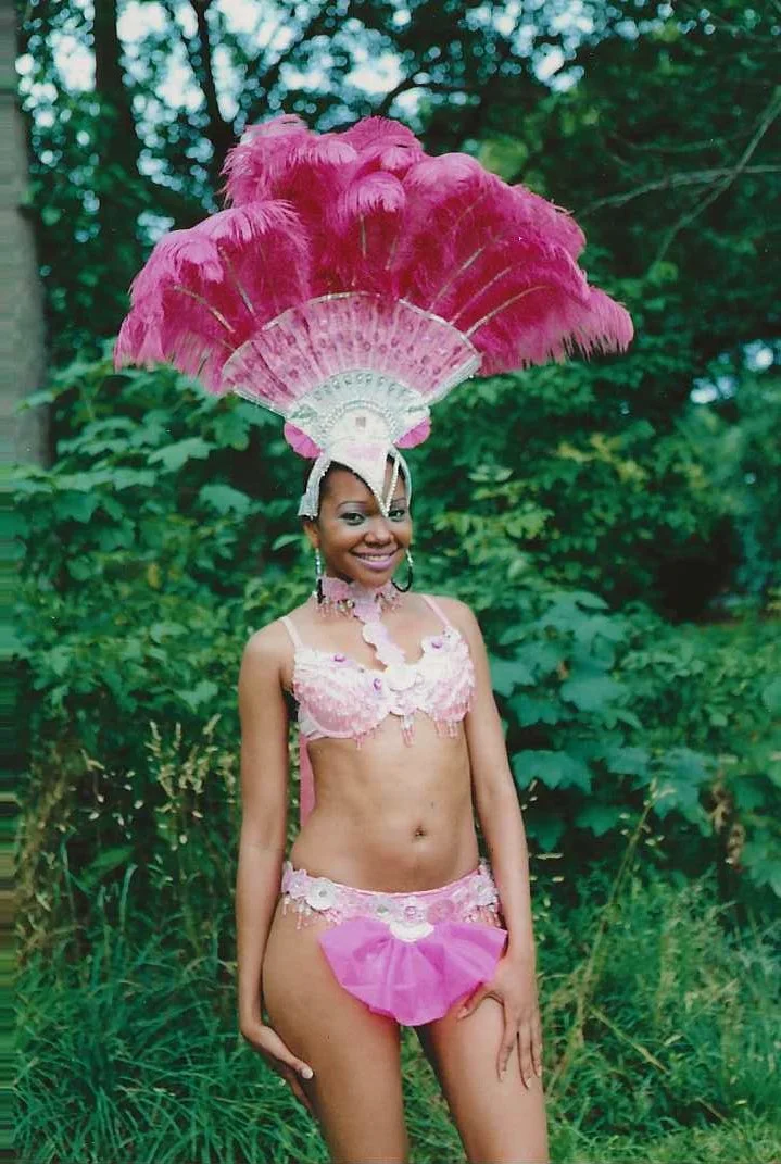 A photograph of a woman wearing a pink feather headdress from Jamel Shabazz’s “Frozen Moments in Time: 1990–2010”