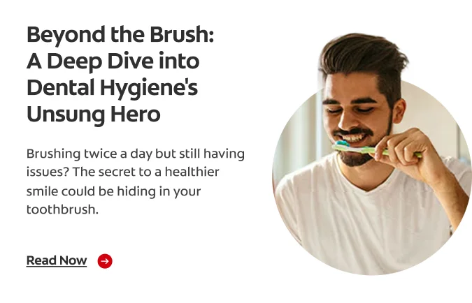 A bearded man smiles as he gets ready to brush his teeth.