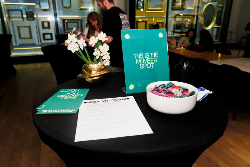 A table with a sign that says “This is the Member Spot”