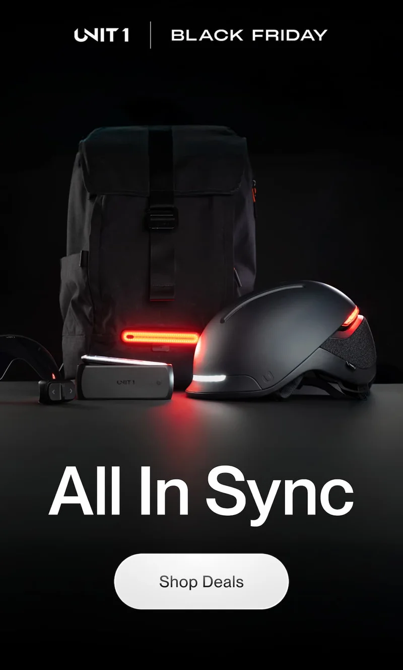 UNIT 1 smart helmet, backpack and lights displayed together glowing in red for the Black Friday promotion.