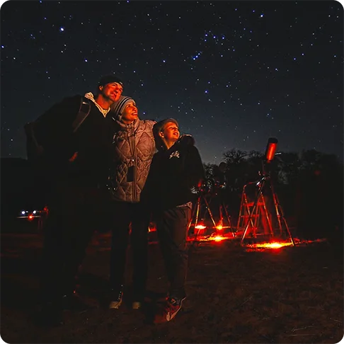 Image Description: Three people looking at the stars.