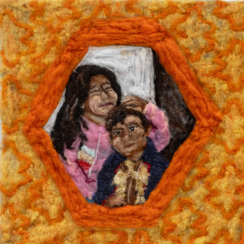 Detail of felted artwork showing a family framed in an orange hexagon