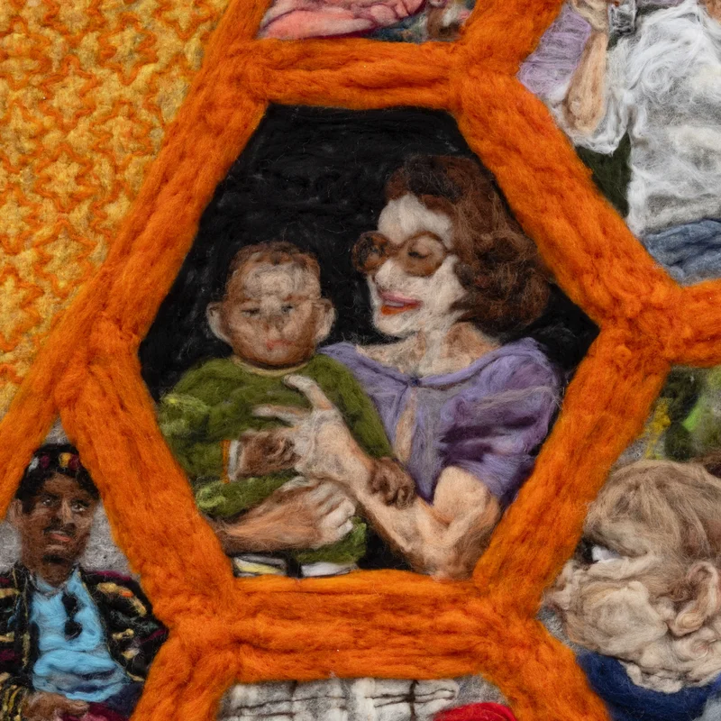 Detail of felted artwork showing a family framed in an orange hexagon