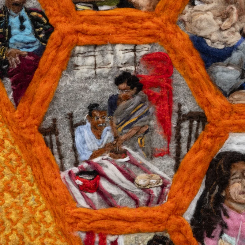 Detail of felted artwork showing a family framed in an orange hexagon