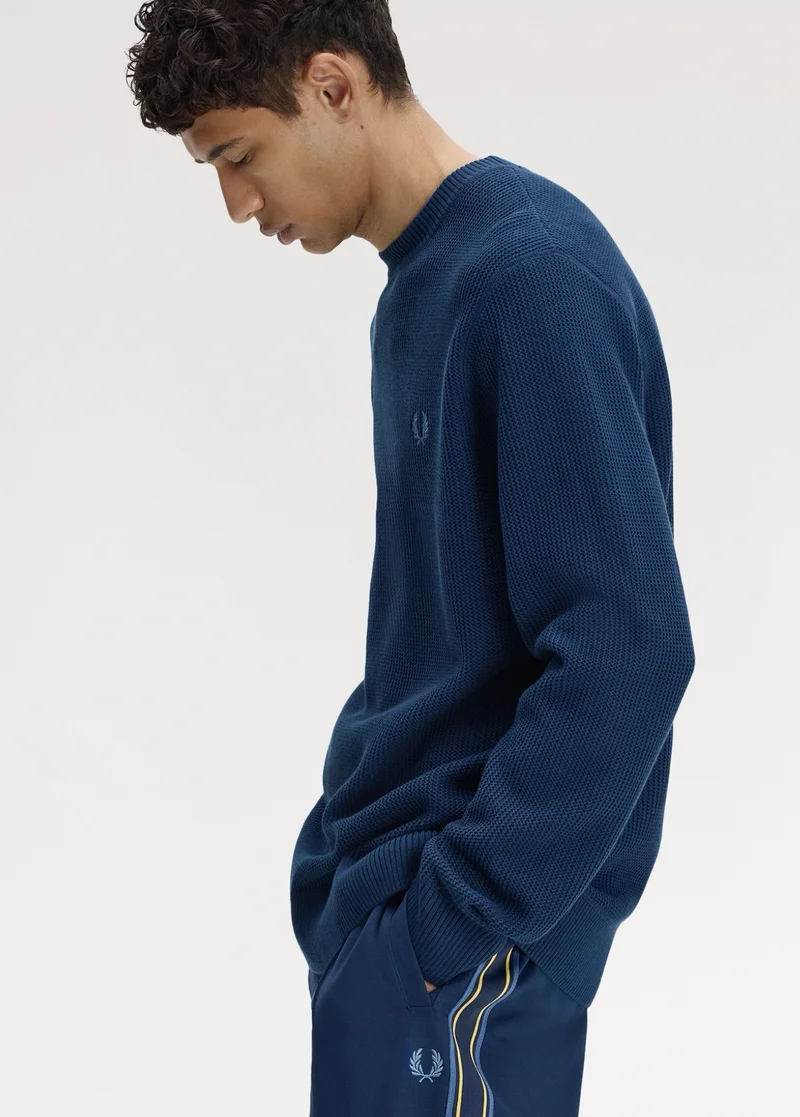 Male model wears a Fred Perry Sport Textured Jumper in Tennis Blue